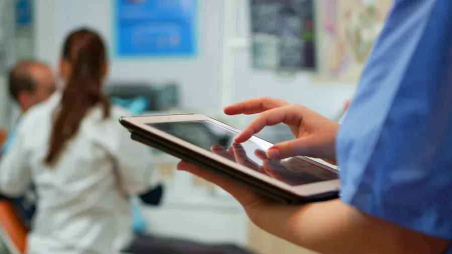 Profesional de la salud consultando datos clínicos en una tableta